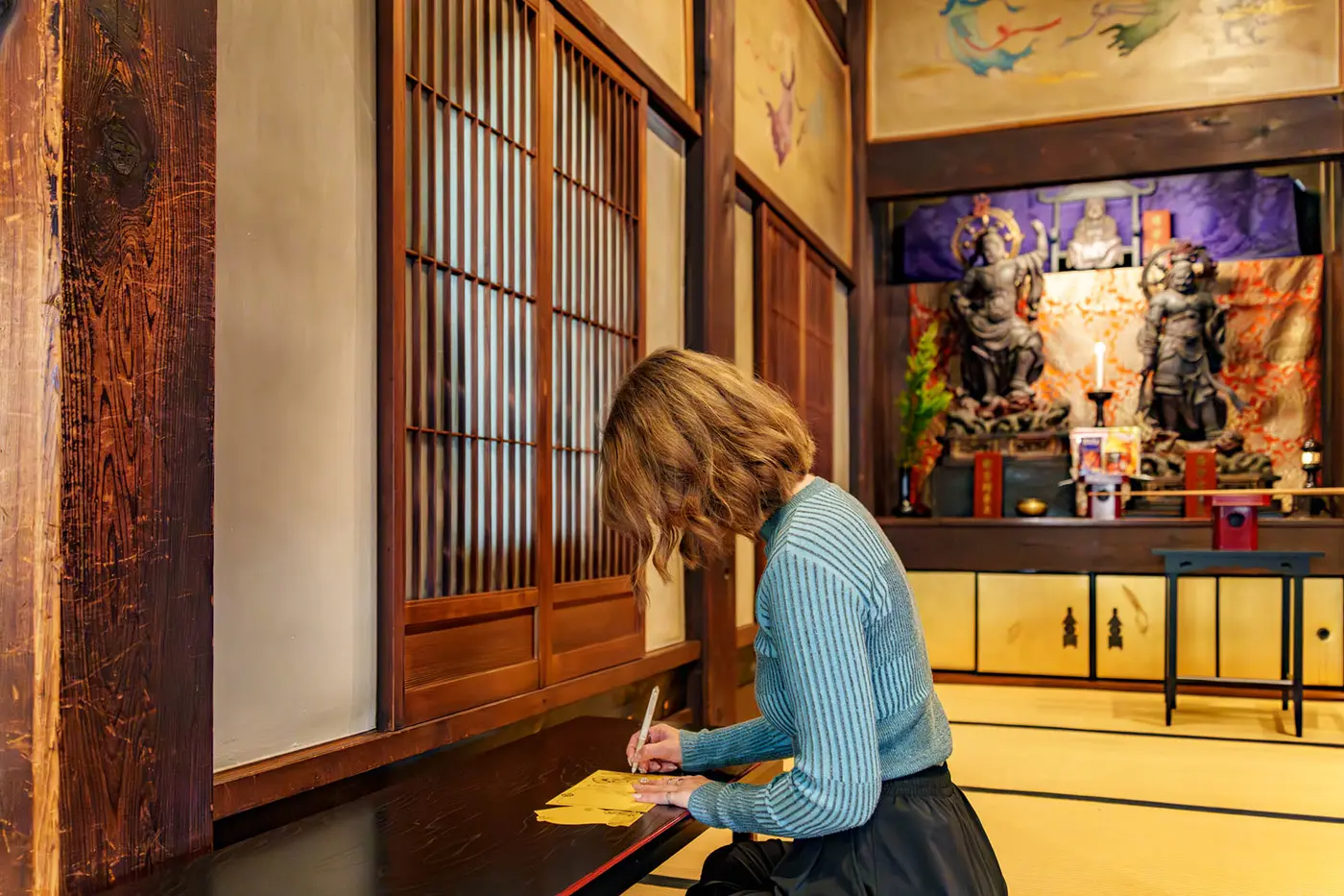 Kira writing a wish on a charm