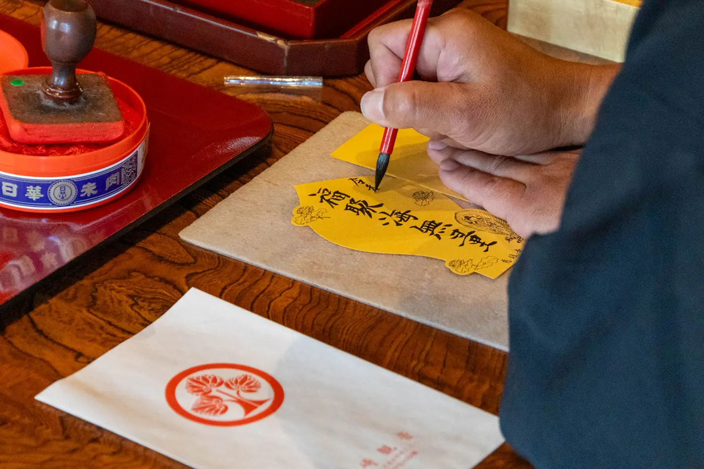 A priest writing calligraphy