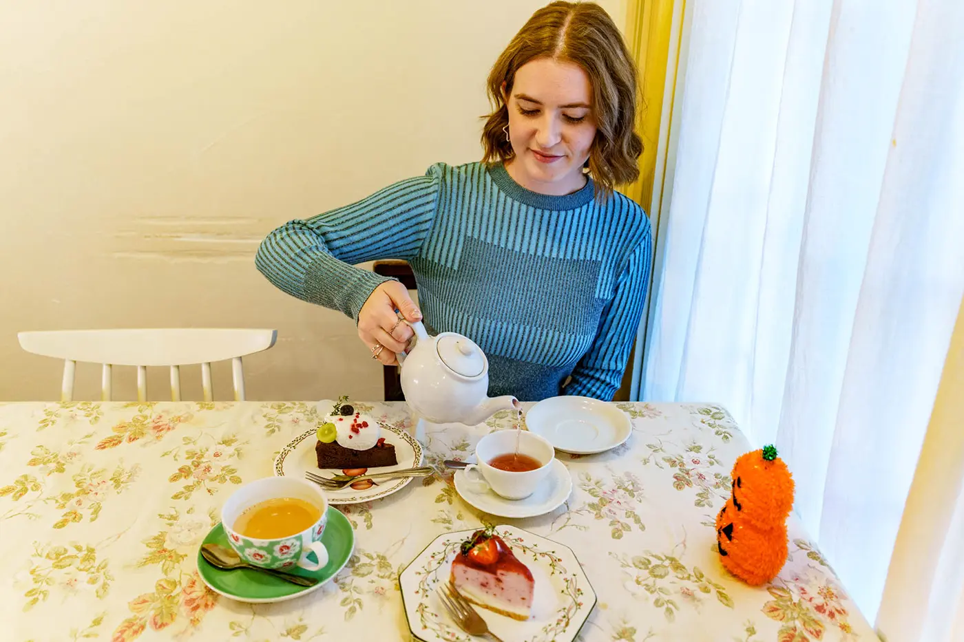 Kira pouring tea into a teacup