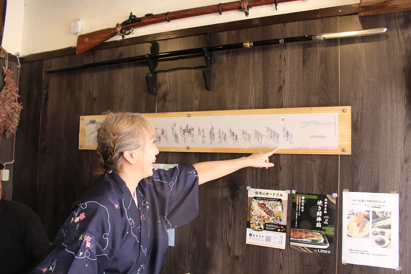 The owner points to a painting from that time hanging on the wall