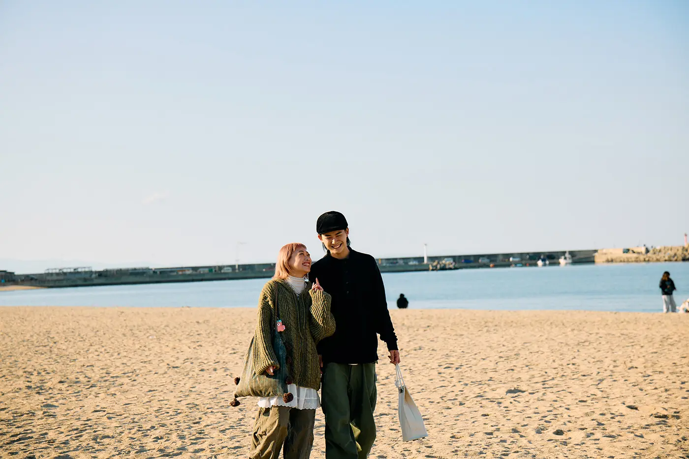 A couple walking on Sennan Marble Beach