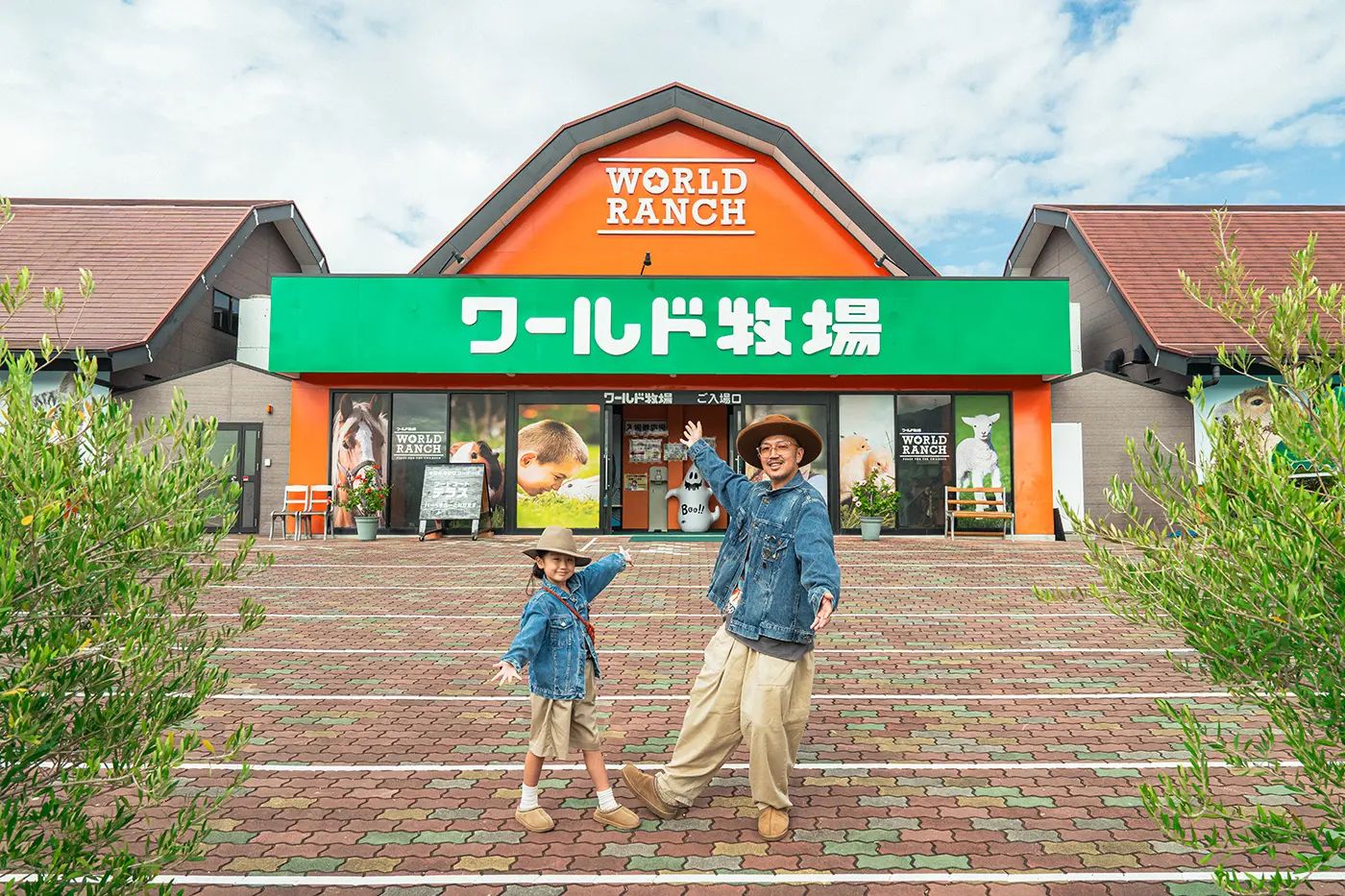 A parent and child standing at the entrance to World Ranch