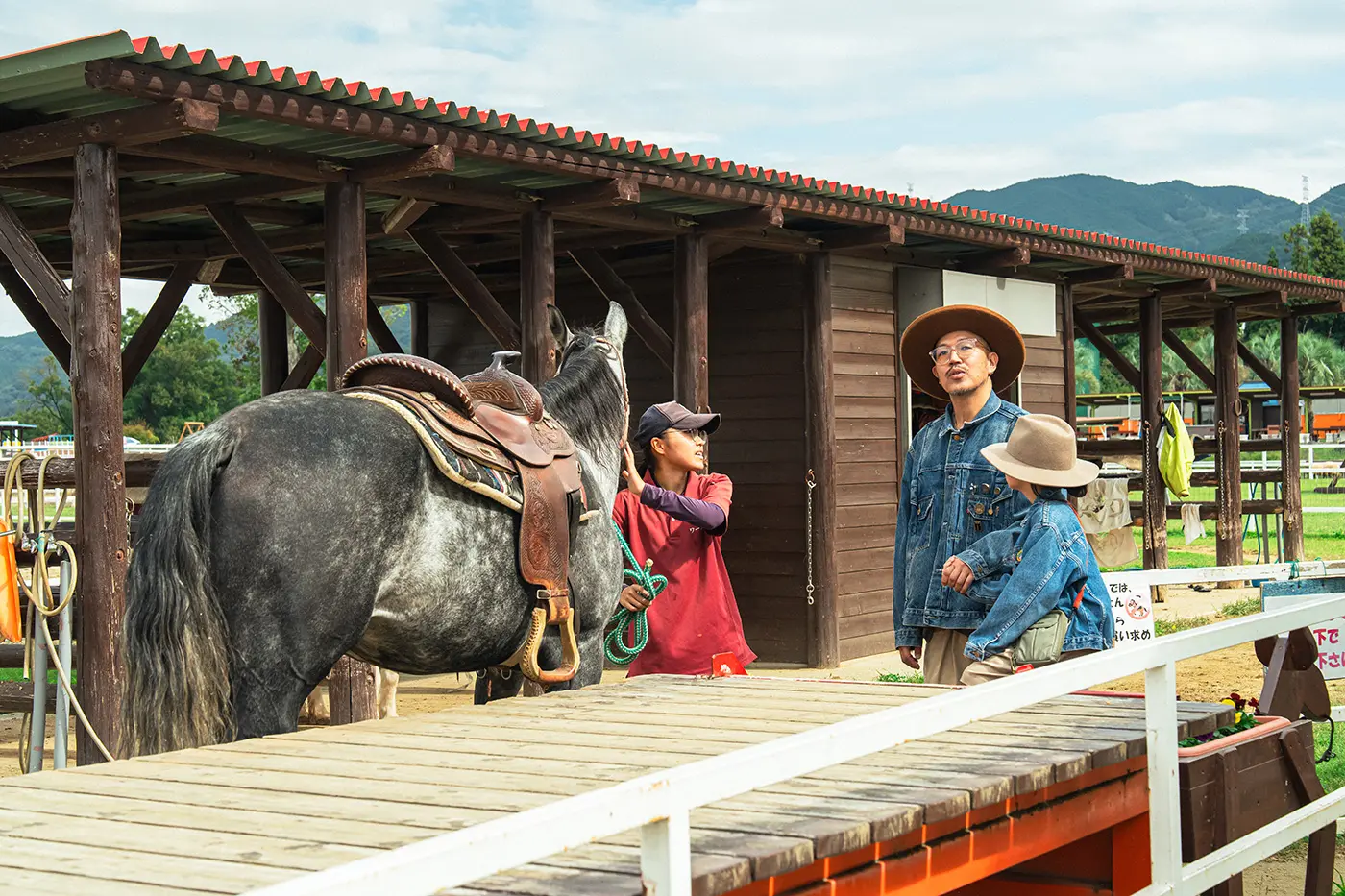Parents and children experiencing horse riding