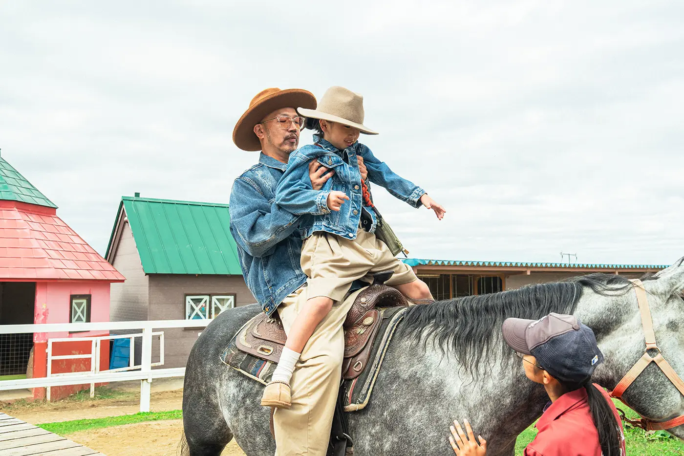 Parents and children experiencing horse riding