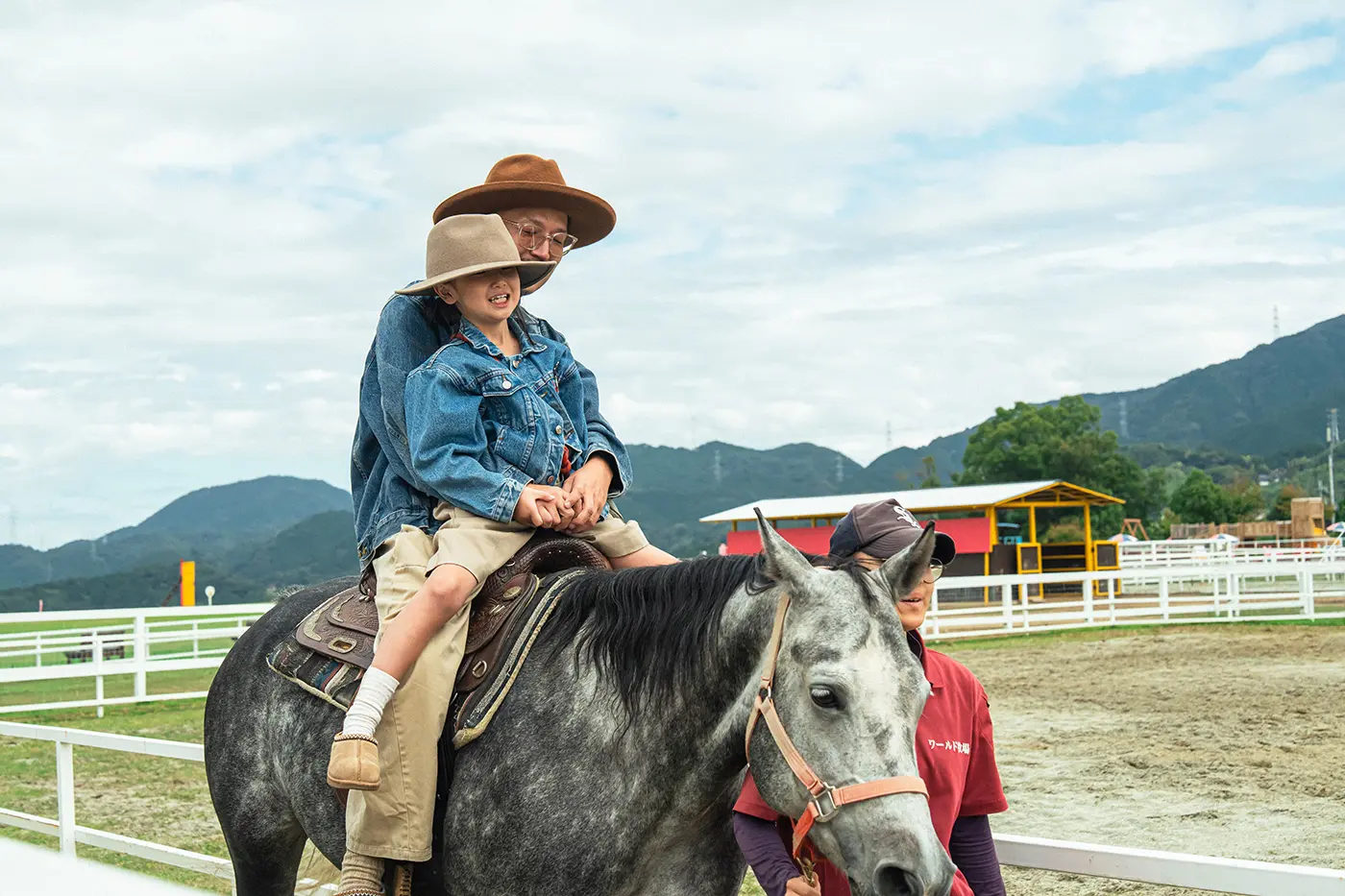 Parents and children enjoying a horse riding experience