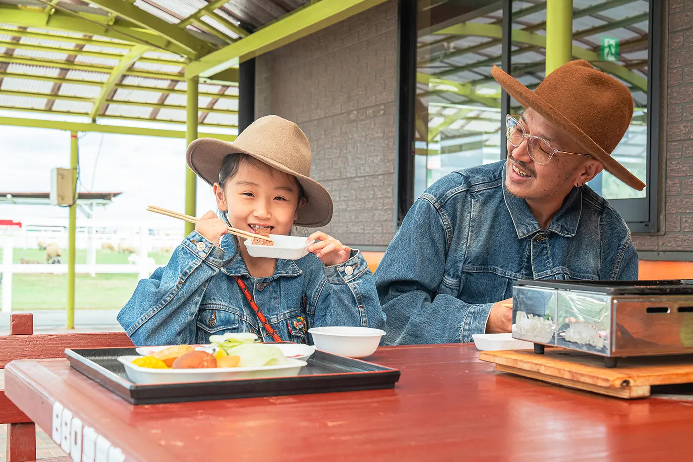 Parents and children enjoying BBQ