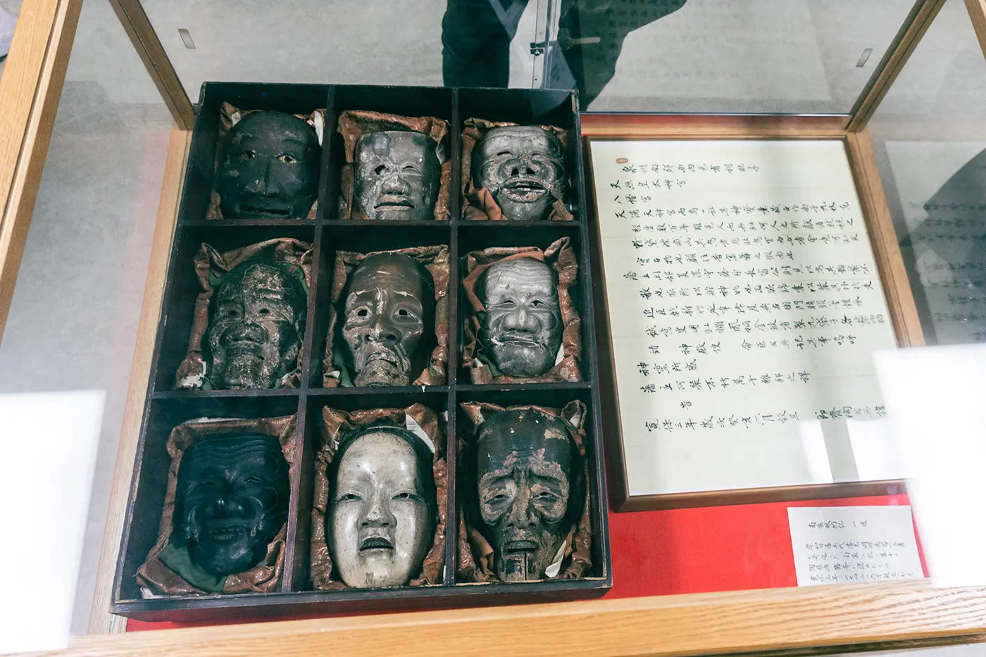 Nine Noh masks stored in a paulownia wood box