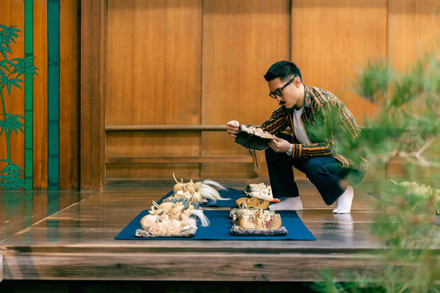 Kurimoto in front of 30 different masks