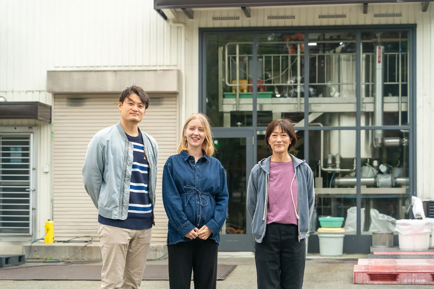President Oshita, Yusuke, and Anne standing side by side
