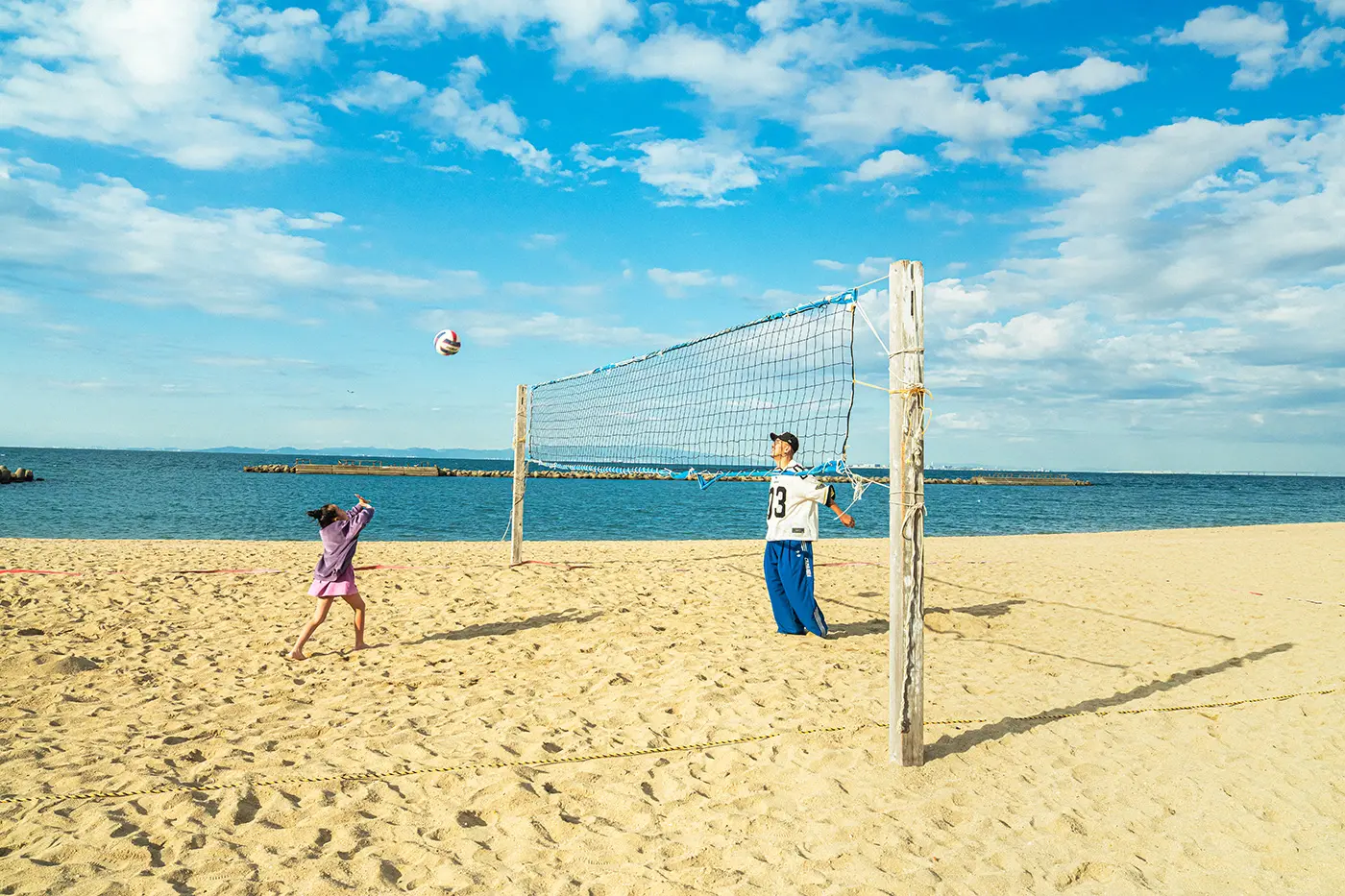 Parents and children enjoying volleyball