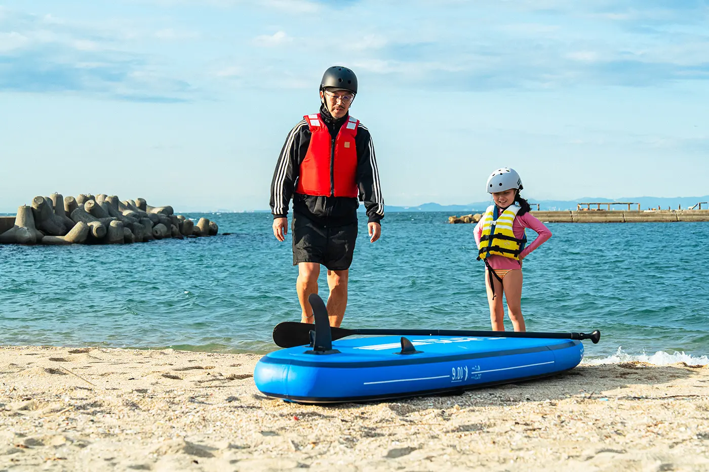 Parents and children practicing SUP