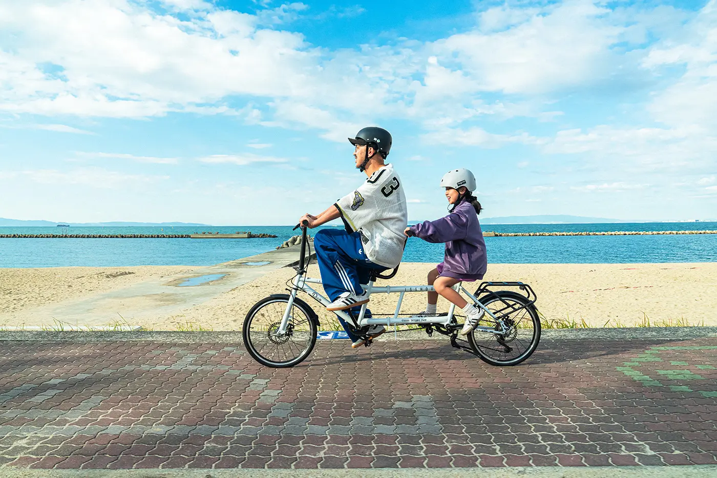 Parent and child riding a tandem bicycle