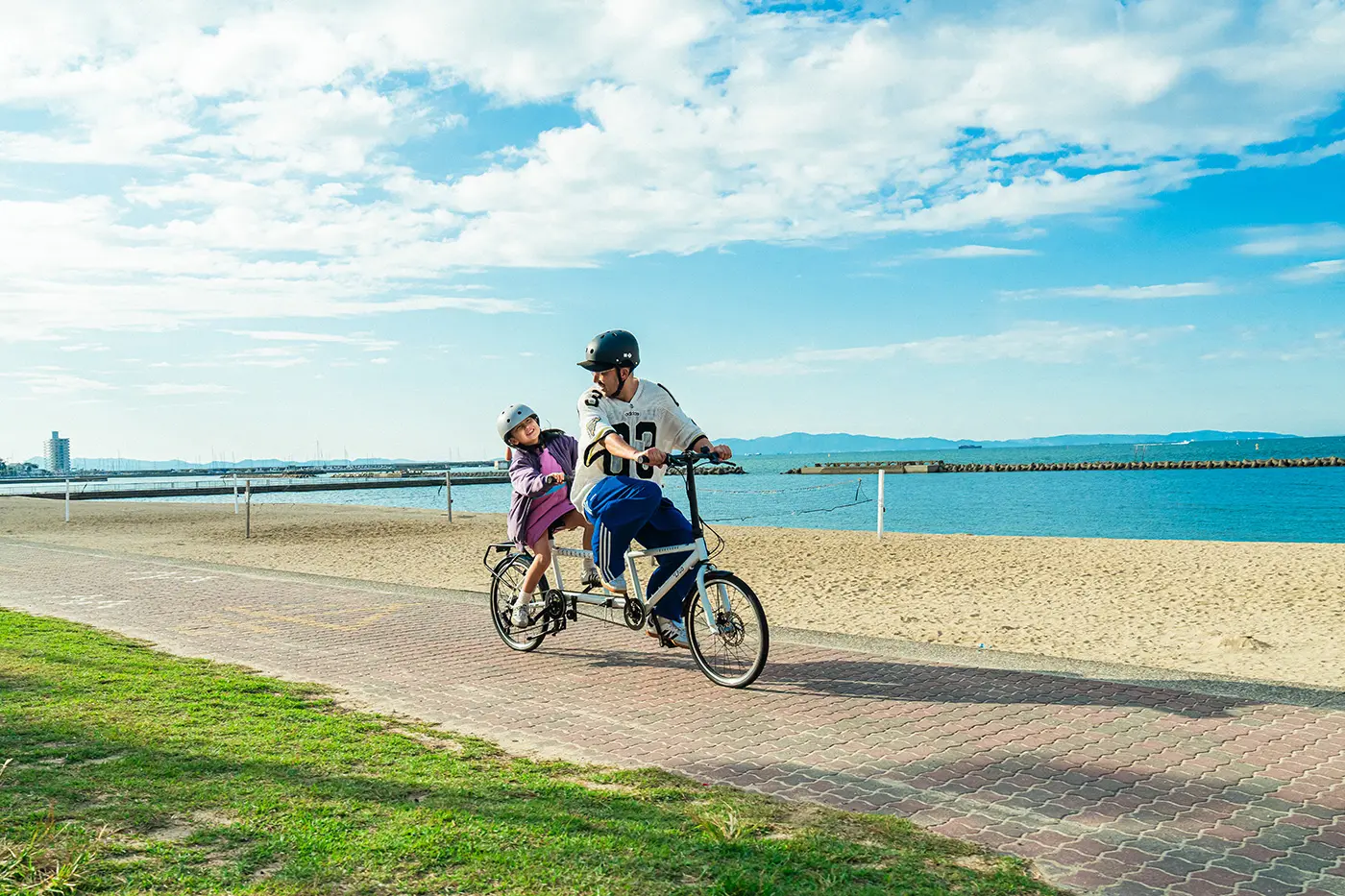 Parent and child riding a tandem bicycle