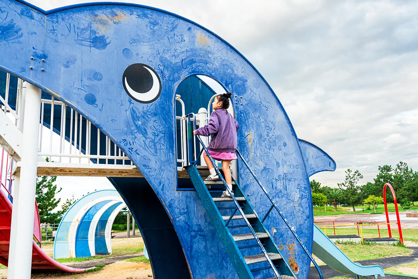 Girl climbing on playground equipment
