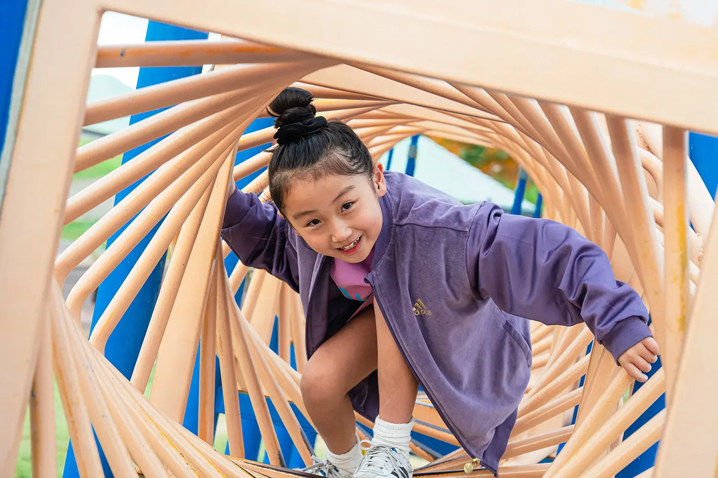 Girl playing with playground equipment