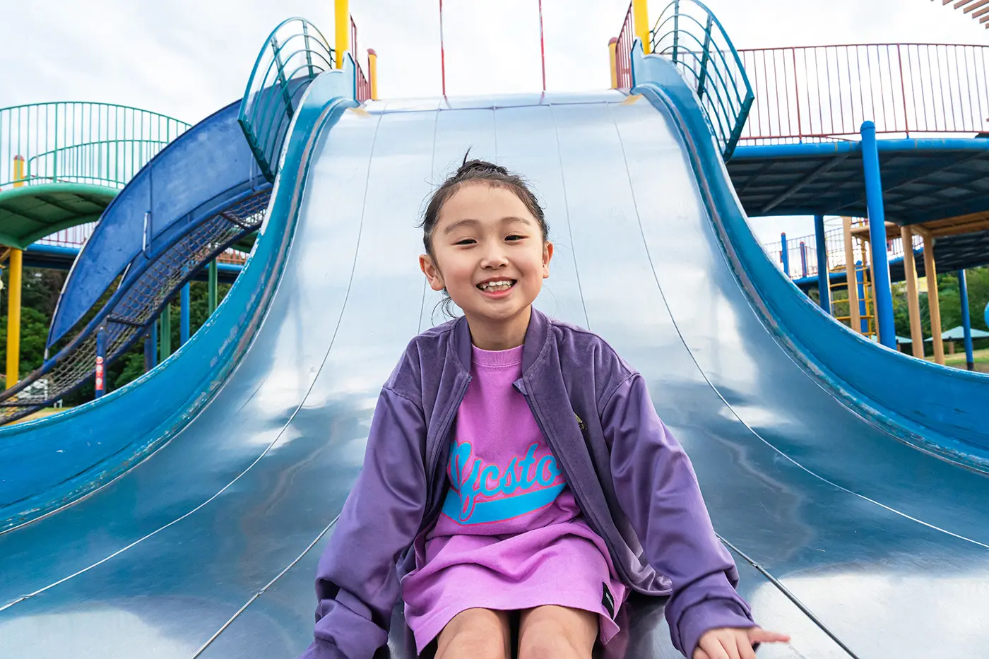 Girl sliding down a slide