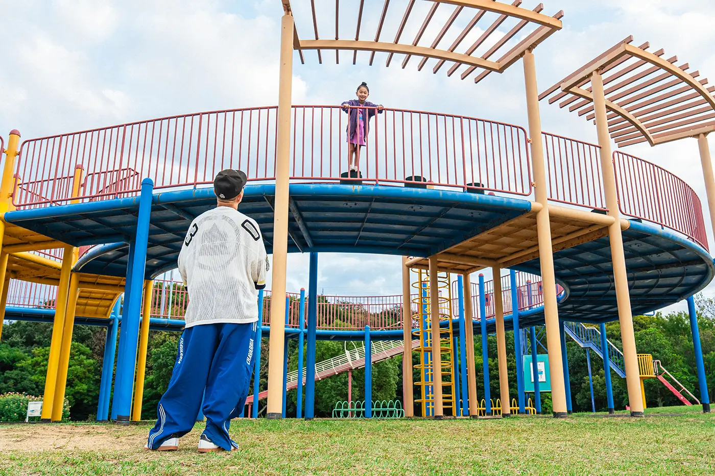 Parents and children playing on playground equipment