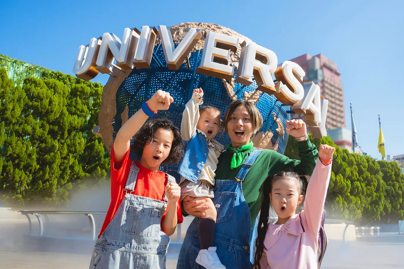 A family in front of a monument at Universal Studios Japan
